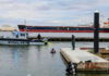 Police boat near dock with divers in water
