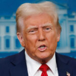 Man speaking at press conference podium