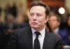 Man in suit at an event looking sideways