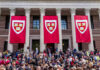Harvard graduation ceremony with banners and crowd outside