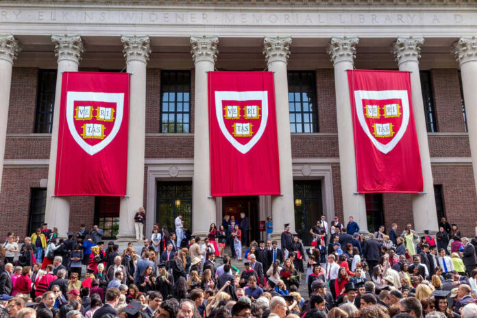 197551889 Harvard graduation ceremony with banners and crowd outside