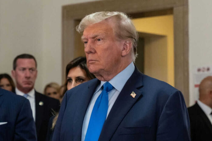 Man in blue suit with serious expression indoors