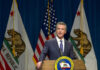 Newsom’s Top Aide INDICTED – Corruption Explodes in Sacramento Man speaking at podium with California and US flags