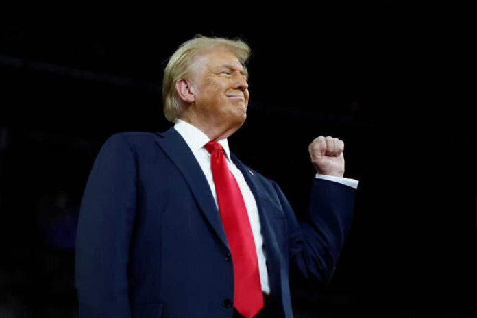Man in suit with raised fist in air
