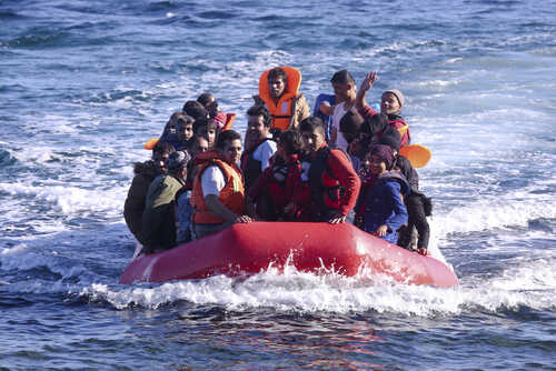 A group of people in a red inflatable boat on the ocean