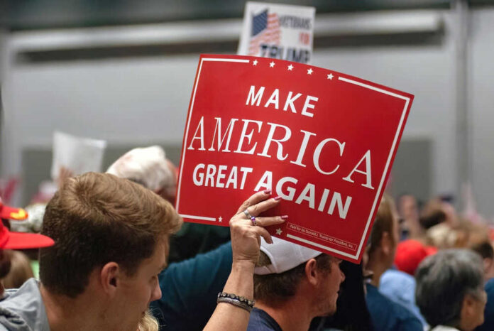 Person holding Make America Great Again sign