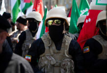 Iran COLLAPSES — Historic Bazaar Shuts Down Soldiers in formation with flags and helmets visible