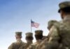 Congress Betrays Military Families Soldiers standing in formation with an American flag in the background